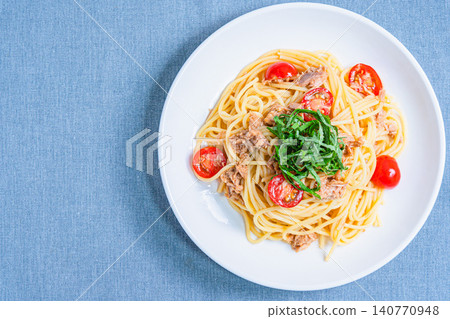 Cold pasta with tuna and cherry tomatoes, garnished with shiso leaves - a perfect summer dish. Cold pasta with tuna and cherry tomatoes, garnished with shiso leaves - a perfect summer dish. 140770948