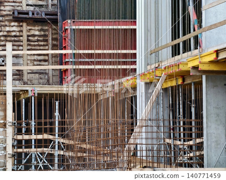 Industrial construction scene. Construction environment featuring steel framework and brick background 140771459
