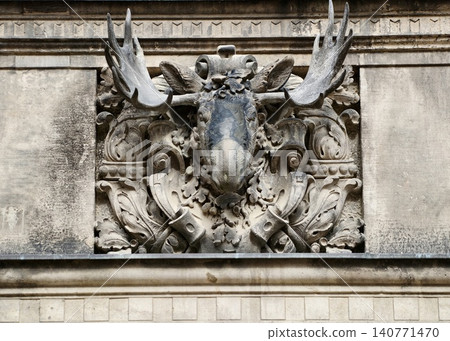 Weathered sculpture depicting historic heraldry. Deep relief stone stag emblem for heritage stories Weathered sculpture depicting historic heraldry. Deep relief stone stag emblem for heritage stories 140771470