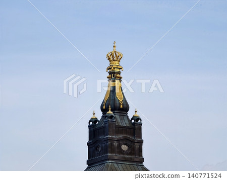 Photographer captures reflective gilded ornament on turret for historical archive purposes Photographer captures reflective gilded ornament on turret for historical archive purposes 140771524