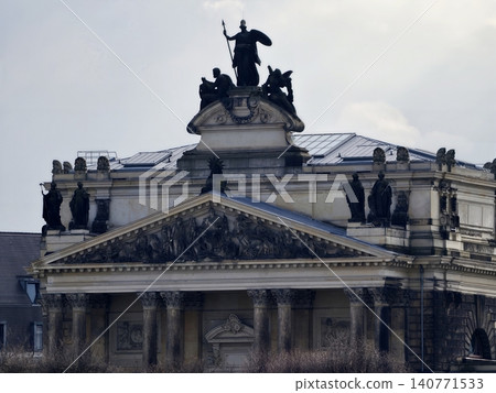 Ornate pediment features equestrian statues and symbolic groupings with prominent skyline silhouette Ornate pediment features equestrian statues and symbolic groupings with prominent skyline silhouette 140771533