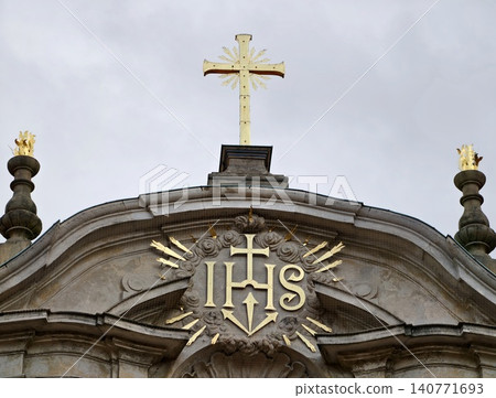 Closeup of classic European church facade showcasing intricate gold details and reverent craftsmanship Closeup of classic European church facade showcasing intricate gold details and reverent craftsmanship 140771693