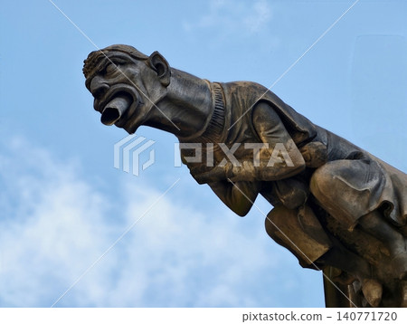 Closeup of historic gargoyle showcasing intricate carvings and atmospheric lighting effects Closeup of historic gargoyle showcasing intricate carvings and atmospheric lighting effects 140771720