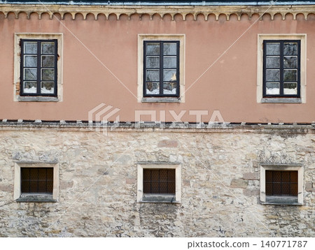 Solid stone foundation with small slit windows and rugged exterior suitable for structural analysis Solid stone foundation with small slit windows and rugged exterior suitable for structural analysis 140771787