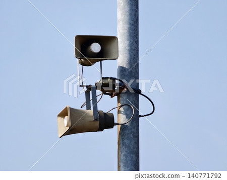 Municipal alert and broadcasting devices featuring aged finish installed outdoors with exposed wiring Municipal alert and broadcasting devices featuring aged finish installed outdoors with exposed wiring 140771792
