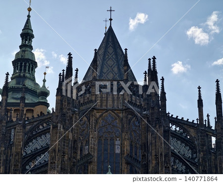 Gothic cathedral imagery. Architectural photograph capturing Gothic church elements beneath stormy sky Gothic cathedral imagery. Architectural photograph capturing Gothic church elements beneath stormy sky 140771864