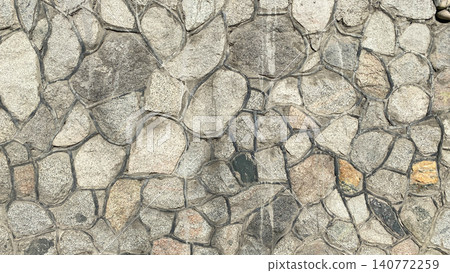 A wall of stones of different sizes and colors. Beautiful texture of stone masonry with veins. A wall of stones of different sizes and colors. Beautiful texture of stone masonry with veins. 140772259