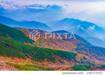 Autumn morning light, the peak of autumn foliage on Mount Norikura - a beautiful landscape of vibrant autumn colors spreading dynamically towards the lower right. Autumn morning light, the peak of autumn foliage on Mount Norikura - a beautiful landscape of vibrant autumn colors spreading dynamically towards the lower right. 140772557