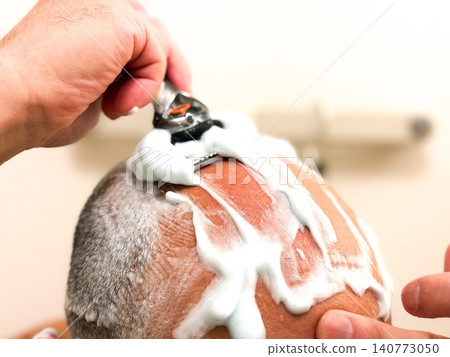 A middle-aged man with a shaved head. A middle-aged man with a shaved head. 140773050