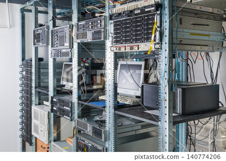 back side of server room with server racks and desktop computer 140774206