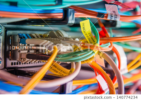detail of server rack with fiber optic cables attached to front detail of server rack with fiber optic cables attached to front 140774234