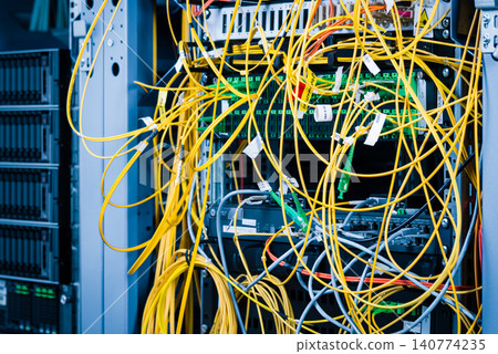 detail of server rack with fiber optic cables attached to front detail of server rack with fiber optic cables attached to front 140774235