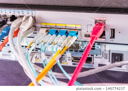 Fiber Optic cables connected to optic ports, network cables conn Fiber Optic cables connected to optic ports, network cables conn 140774237