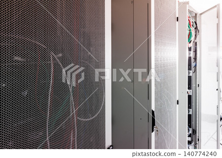 Racks filled with computer hardware inside internet datacenter 140774240