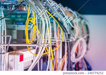 Detail of server room with bunch of fiber optic cables at the ba Detail of server room with bunch of fiber optic cables at the ba 140774252