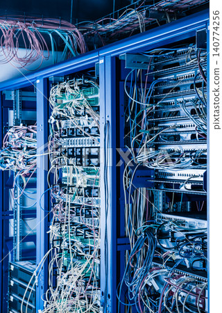 Server rack with fiber optic cables attached to front panel swit Server rack with fiber optic cables attached to front panel swit 140774256