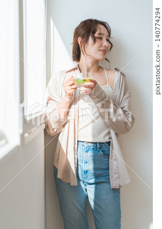 Women who drink detox water, lemon water, and mint water. 140774294