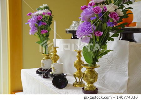 Flowers and Buddhist implements arranged on the altar for the memorial service Flowers and Buddhist implements arranged on the altar for the memorial service 140774330