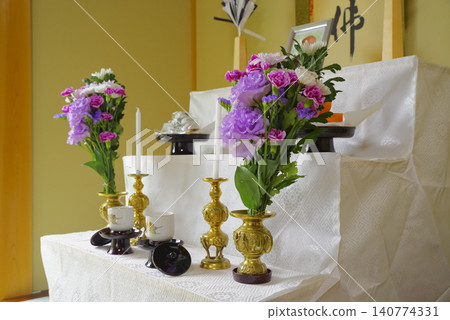 Flowers and Buddhist implements arranged on the altar for the memorial service 140774331
