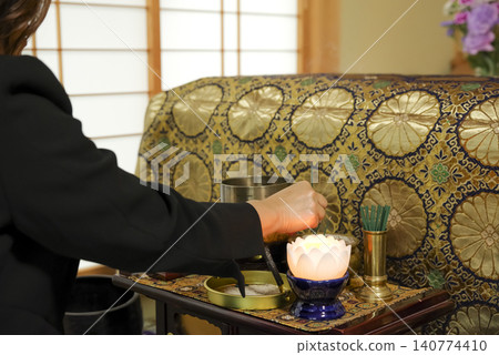 A woman mourns the passing of the deceased at a funeral. A woman mourns the passing of the deceased at a funeral. 140774410