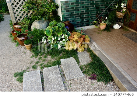 A small garden in front of the entrance of a Showa-era house A small garden in front of the entrance of a Showa-era house 140774466