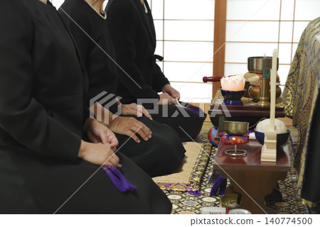 Mourners paying their respects to the deceased Mourners paying their respects to the deceased 140774500