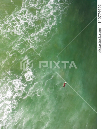 Surfer in the wavy sea Surfer in the wavy sea 140774692