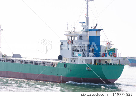 A cargo ship departing from the Takasago Industrial Zone. A cargo ship departing from the Takasago Industrial Zone. 140774825