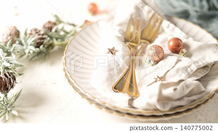 Elegant Christmas Table Setting with Gold Cutlery and Festive Ornaments 140775002