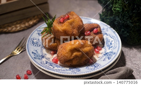 Traditional fried dough fritters topped with pomegranate seeds 140775016