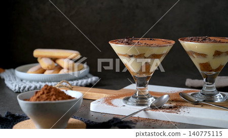 Classic Italian Tiramisu Served in Elegant stemmed cocktail Glasses Classic Italian Tiramisu Served in Elegant stemmed cocktail Glasses 140775115
