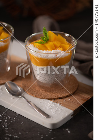 Chia Seed Pudding with Mango Puree and Fresh Mint in a Glass Chia Seed Pudding with Mango Puree and Fresh Mint in a Glass 140775141