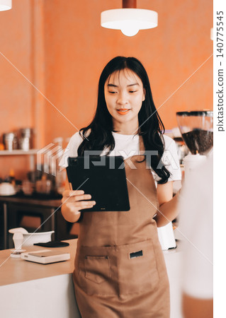 Young woman at barista school learning how to make espresso coffee. 140775545