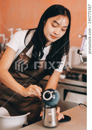Young woman at barista school learning how to make espresso coffee. Young woman at barista school learning how to make espresso coffee. 140775567
