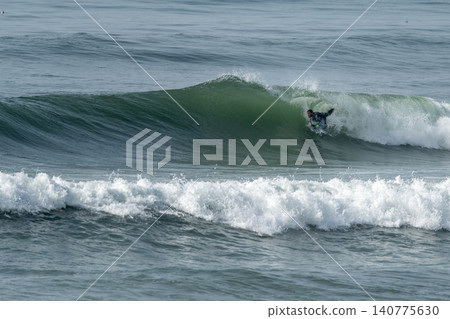 Bodyboarder riding a wave Bodyboarder riding a wave 140775630
