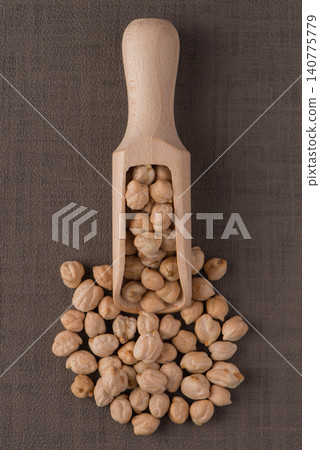 Wooden scoop with chickpeas Wooden scoop with chickpeas 140775779