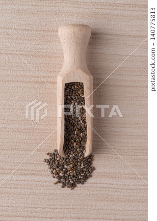 Wooden scoop with chia seeds Wooden scoop with chia seeds 140775813