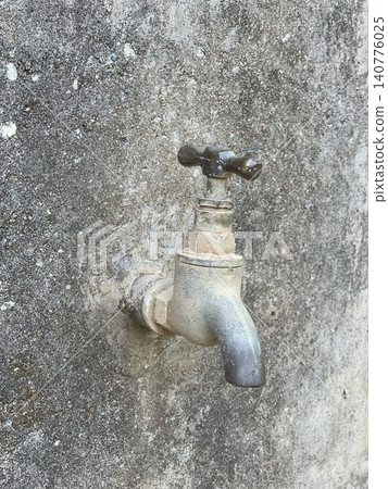 Old Metal Faucet With Cross Handle On Weathered Concrete Wall Old Metal Faucet With Cross Handle On Weathered Concrete Wall 140776025