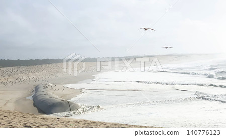 The sea rises to the seafront of Furadouro in Ovar The sea rises to the seafront of Furadouro in Ovar 140776123