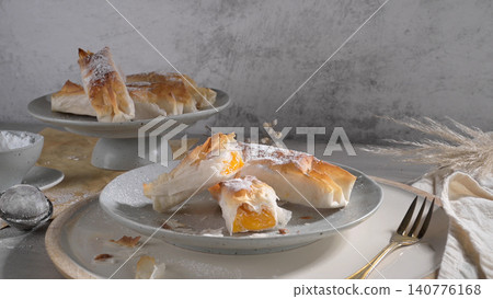 Crispy phyllo pastry rolls filled with sweet egg cream Crispy phyllo pastry rolls filled with sweet egg cream 140776168