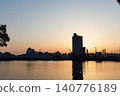 The port and silos of the Takasago Industrial Zone, bathed in the setting sun (Takasago City, Hyogo Prefecture) 140776189