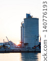 The port and silos of the Takasago Industrial Zone, bathed in the setting sun (Takasago City, Hyogo Prefecture) 140776193