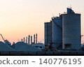 The port and silos of the Takasago Industrial Zone, bathed in the setting sun (Takasago City, Hyogo Prefecture) 140776195