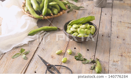 Fresh and raw green broad beans Fresh and raw green broad beans 140776284