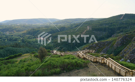 Panoramic view of wooden walkways winding through the mountainous landscape of Cerro da Candosa in Gois Portugal 140776324