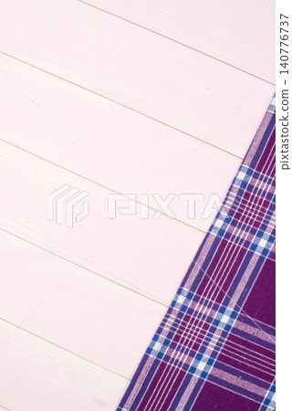 Purple towel over wooden table Purple towel over wooden table 140776737