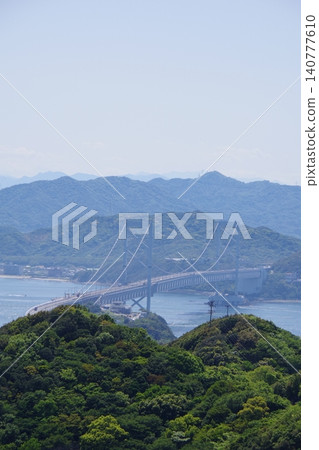 View towards the Great Naruto Bridge from Uzunooka Hill in Minamiawaji City, Hyogo Prefecture. 140777610