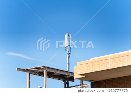Mobile phone base station antenna on rooftop of apartment Mobile phone base station antenna on rooftop of apartment 140777775