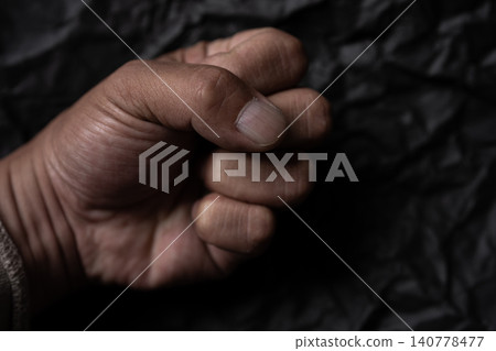 Male hand with a clenched fist Male hand with a clenched fist 140778477