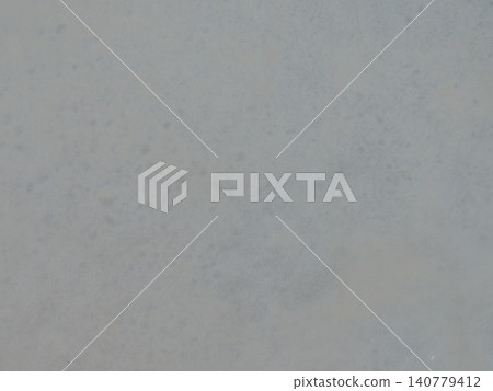 A light gray matte finish with a delicate texture. Soft smoky flecks and subtle blue tones emerge against the blurred background. The finish appears smooth, minimalist, and neutral. A light gray matte finish with a delicate texture. Soft smoky flecks and subtle blue tones emerge against the blurred background. The finish appears smooth, minimalist, and neutral. 140779412